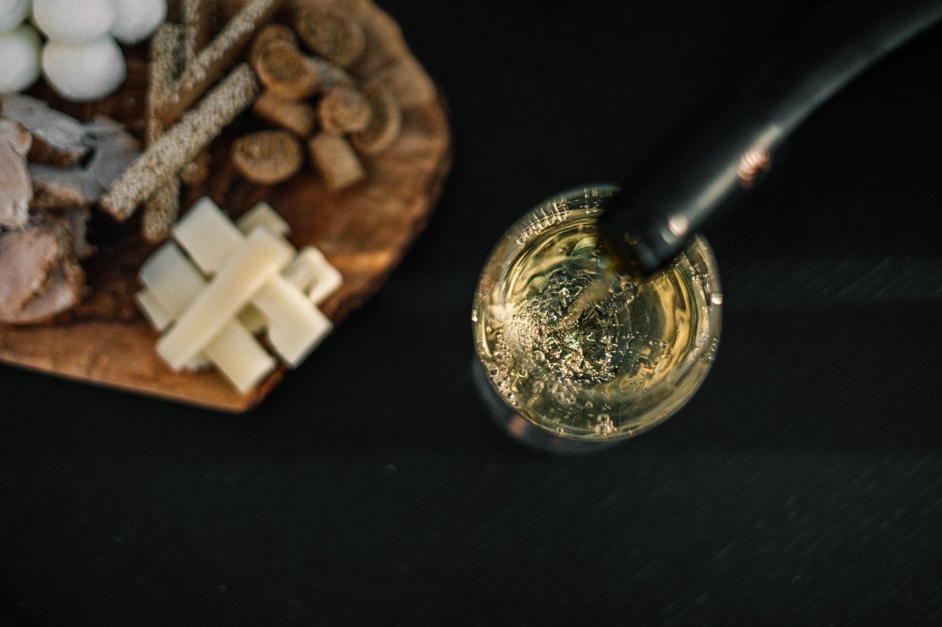 Overhead view of a wine glass and Cretan cheese board